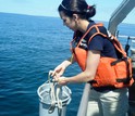 Researcher Kristen Hunter-Cevera uses low-tech bucket-sampling to collect seawater for analysis.